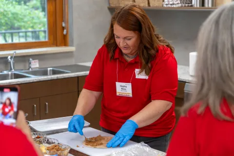 Hayley Moss prepares food at the Cyclone Kitchen tour stop