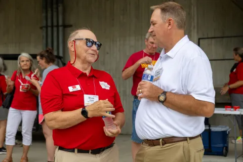 Black Hawk County Extension Council member Bruce Clark talks with Vice President for Extension and Outreach Jason Henderson