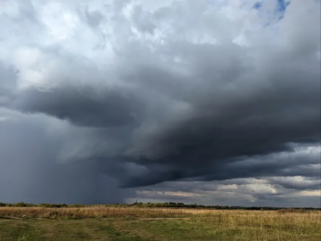 storm gathering over a field